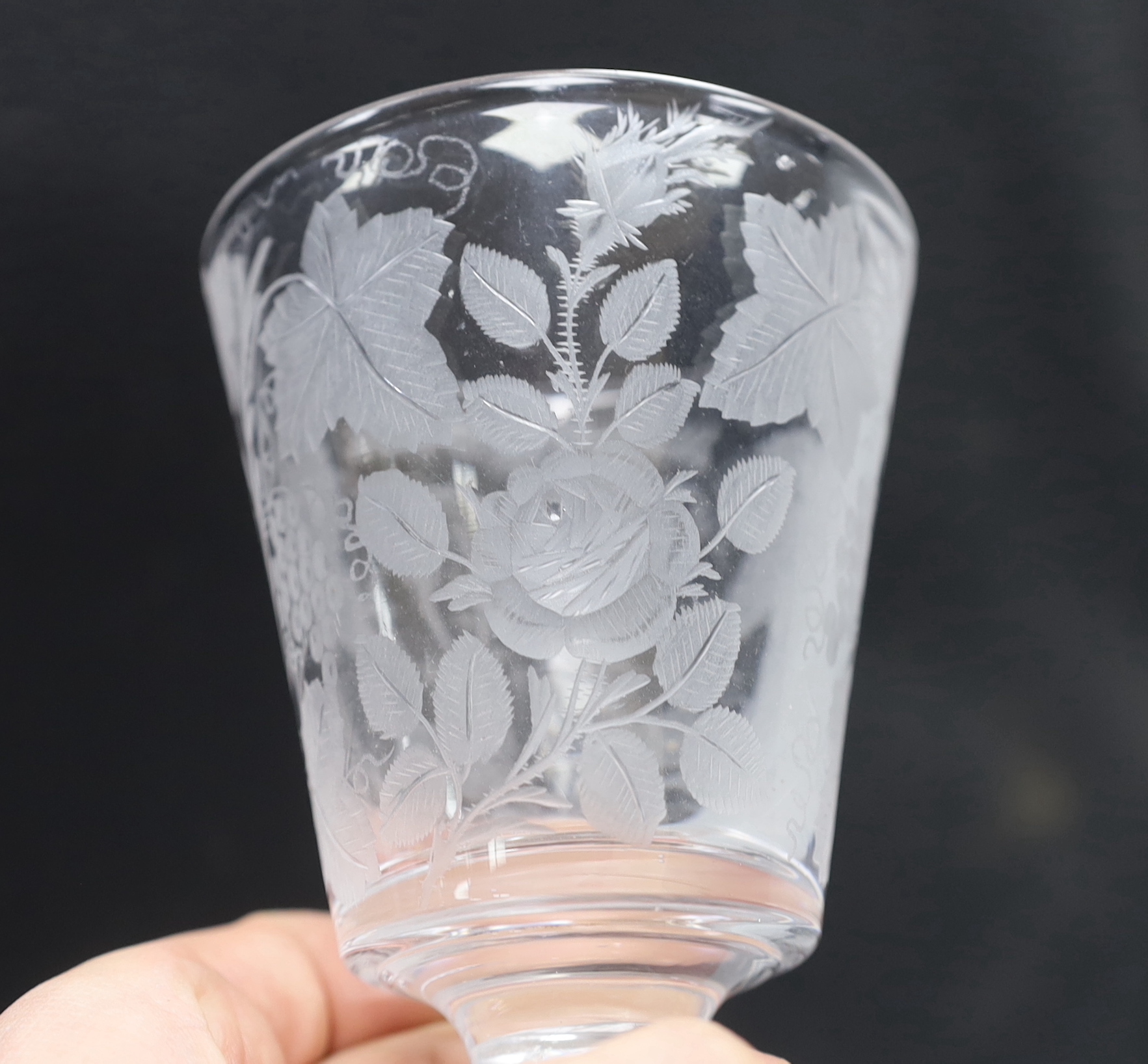 An English lead crystal engraved goblet/rummer, c.1800, bucket bowl, engraved with fruiting vines, a rose and scripted initials, possibly ‘JAB’ or ‘TAB’, capstan stem and plain foot with rough pontil, 13.3cm high
